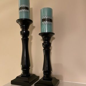 Black wooden candle sticks with candles. 16.5”h and 12.5”h.Good condition.